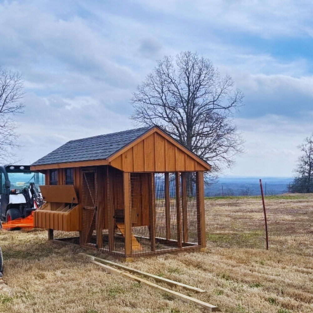 Wooden chicken coop in open field