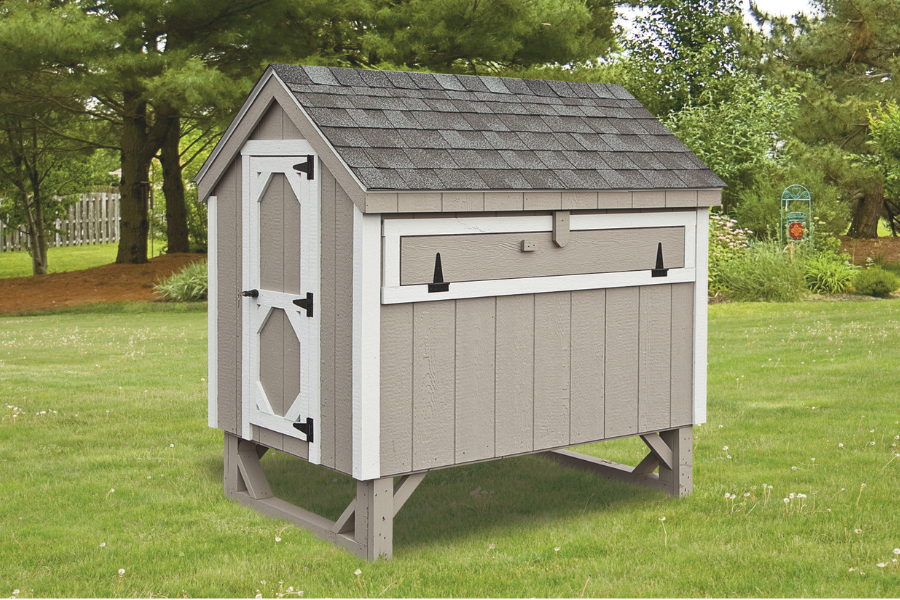tan a frame coop with white trim slightly raised off grass in Little Rock AR