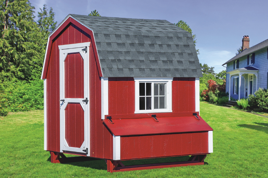 red and white trimmed dutch chicken coop with gray shingle roof and side egg collection box
