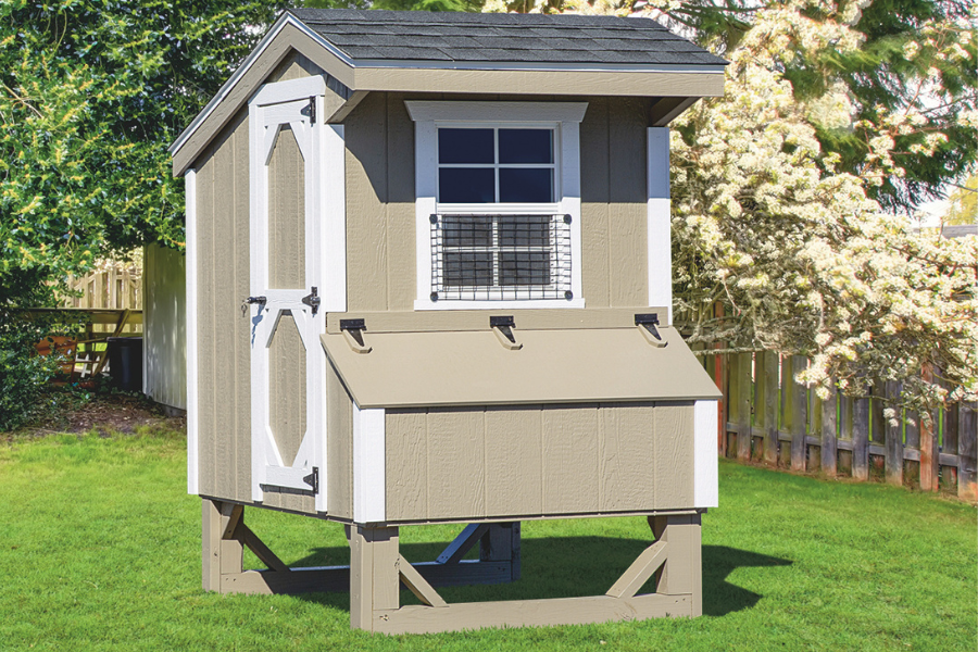 tan and white trimmed quaker coop with front egg collection box and side door
