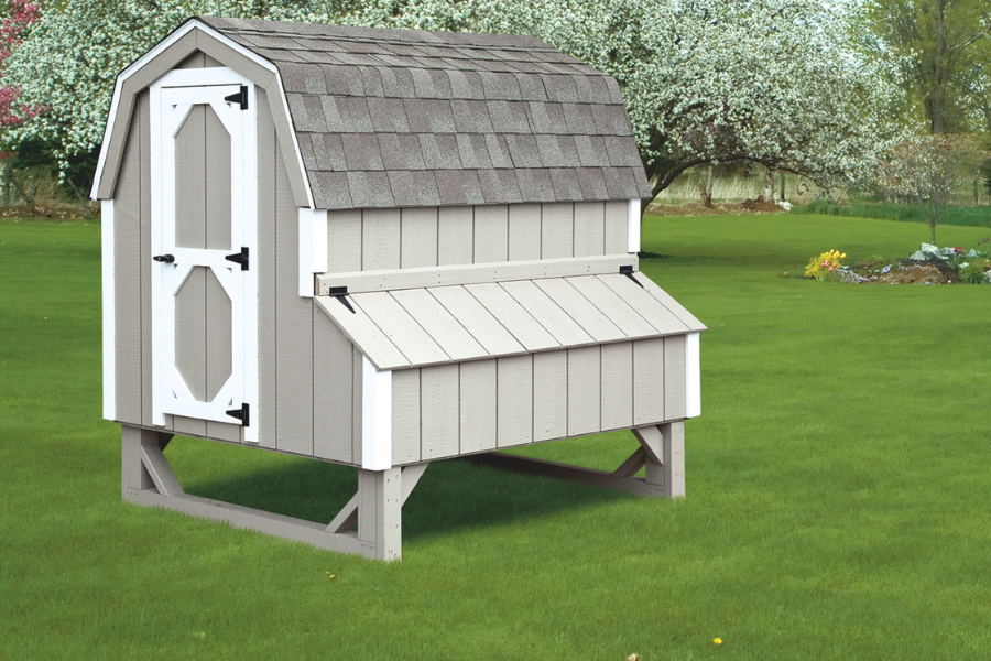gray and white trimmed dutch coop raised off ground with traditional curved gray shingle roof