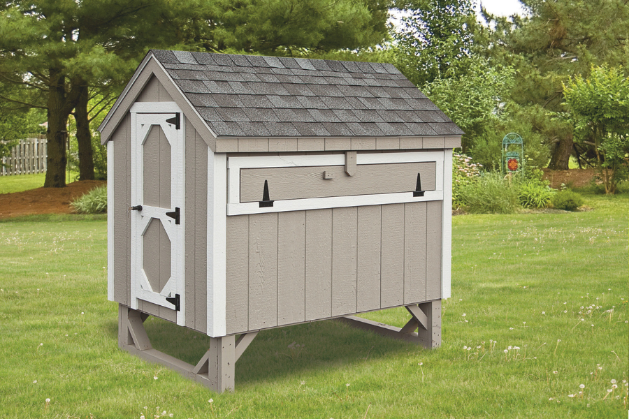 tan a frame chicken coop white trim gray shingle roof slightly raised off ground
