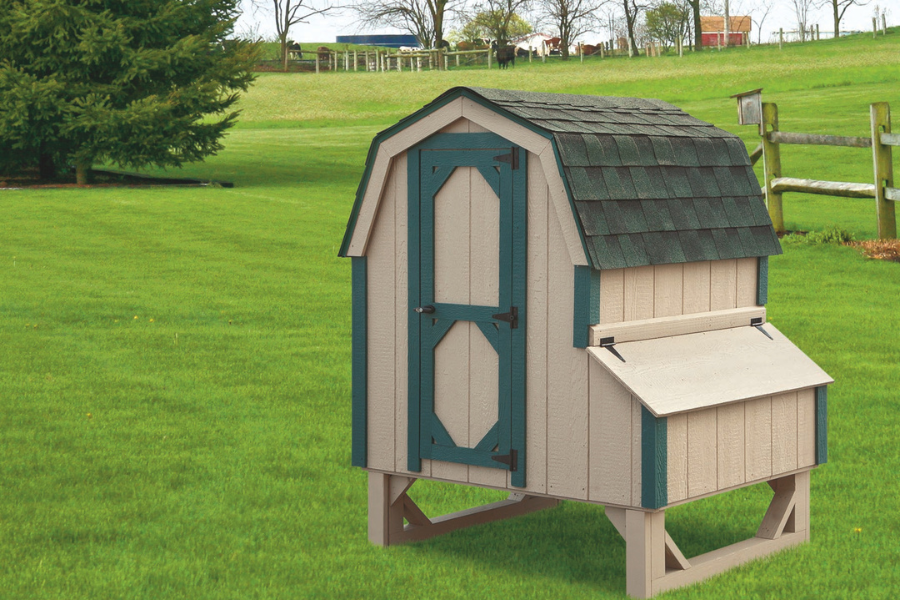 tan dutch coop with green trim and curved greenish shingle roof