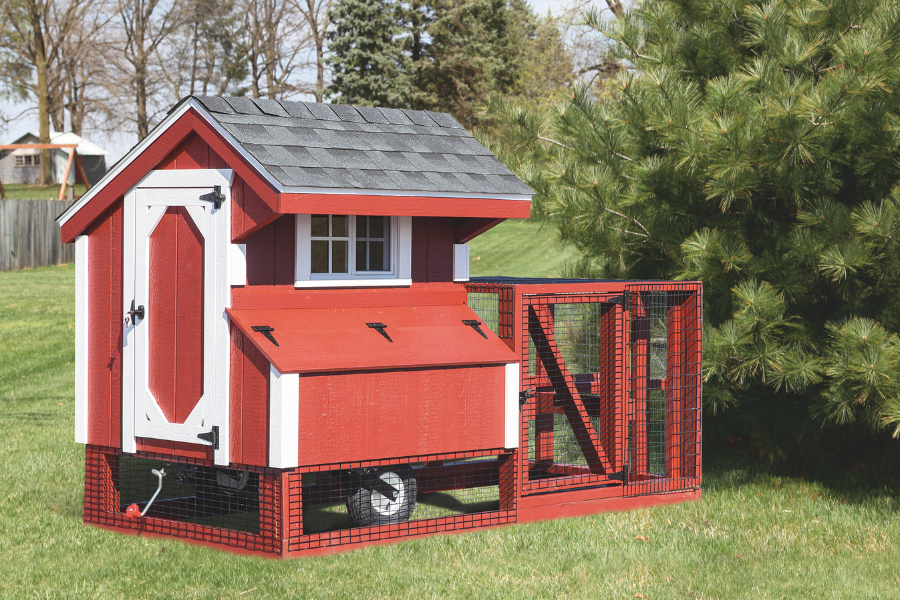 red and white trimmed tractor coop with gray shingle roof attached run wheels and handle