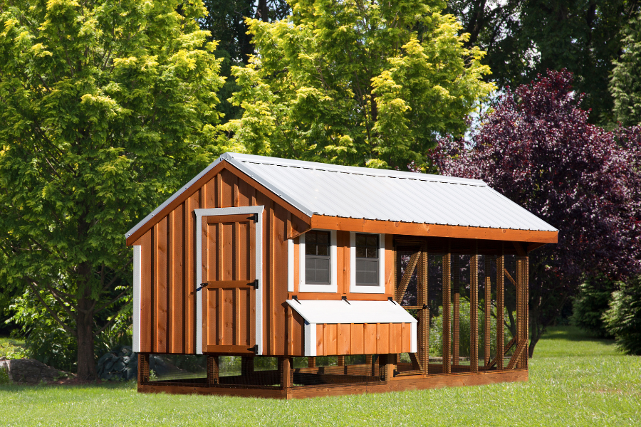 wood and white trimmed combination chicken coop with white metal roof and attached run in Buhl ID