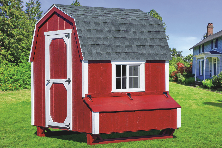 red and white trimmed barn style coop with curved shingle roof