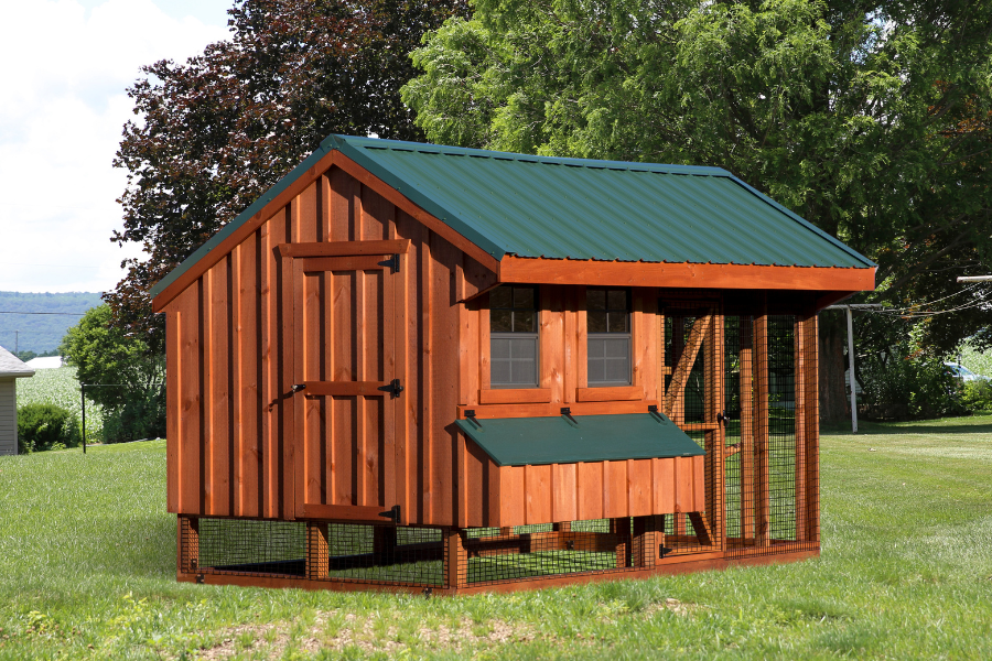 wooden combination chicken coop with green metal roof