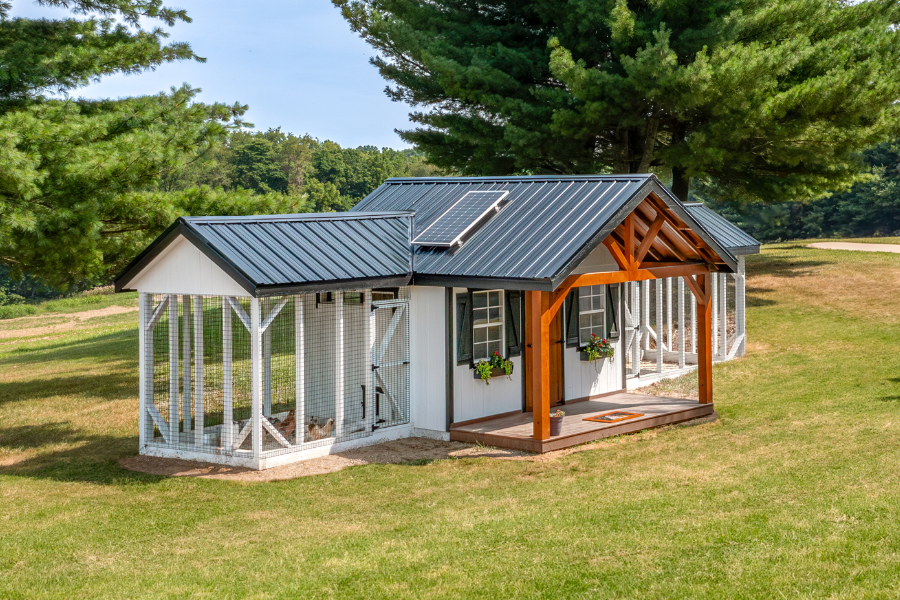 side view of black metal roof solar panel front porch and attached runs on either side of combination coop in Shreveport