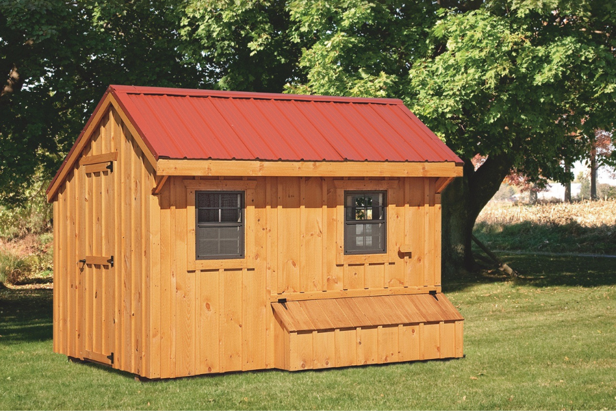 wooden quaker chicken coop with red metal roof