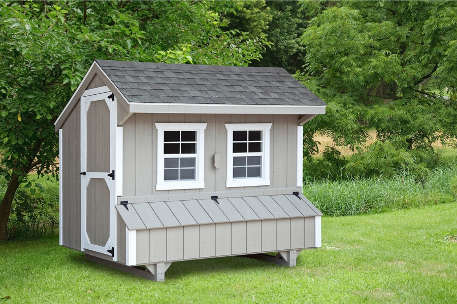 gray and white trimmed quaker chicken coop with white trim two windows and egg collection box plus gray shingle roof