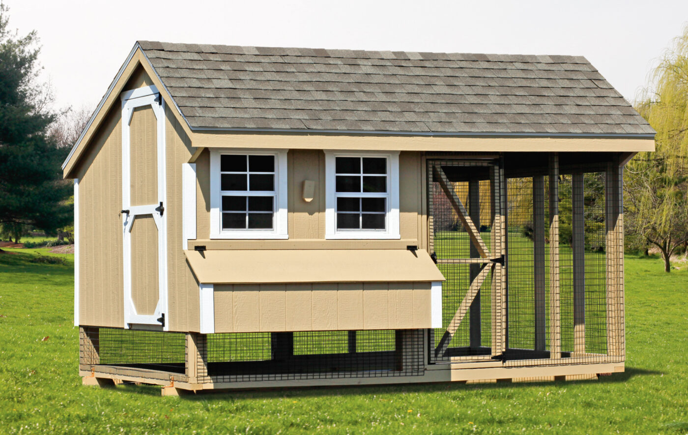 tan combination coop with white trim and an outdoor run