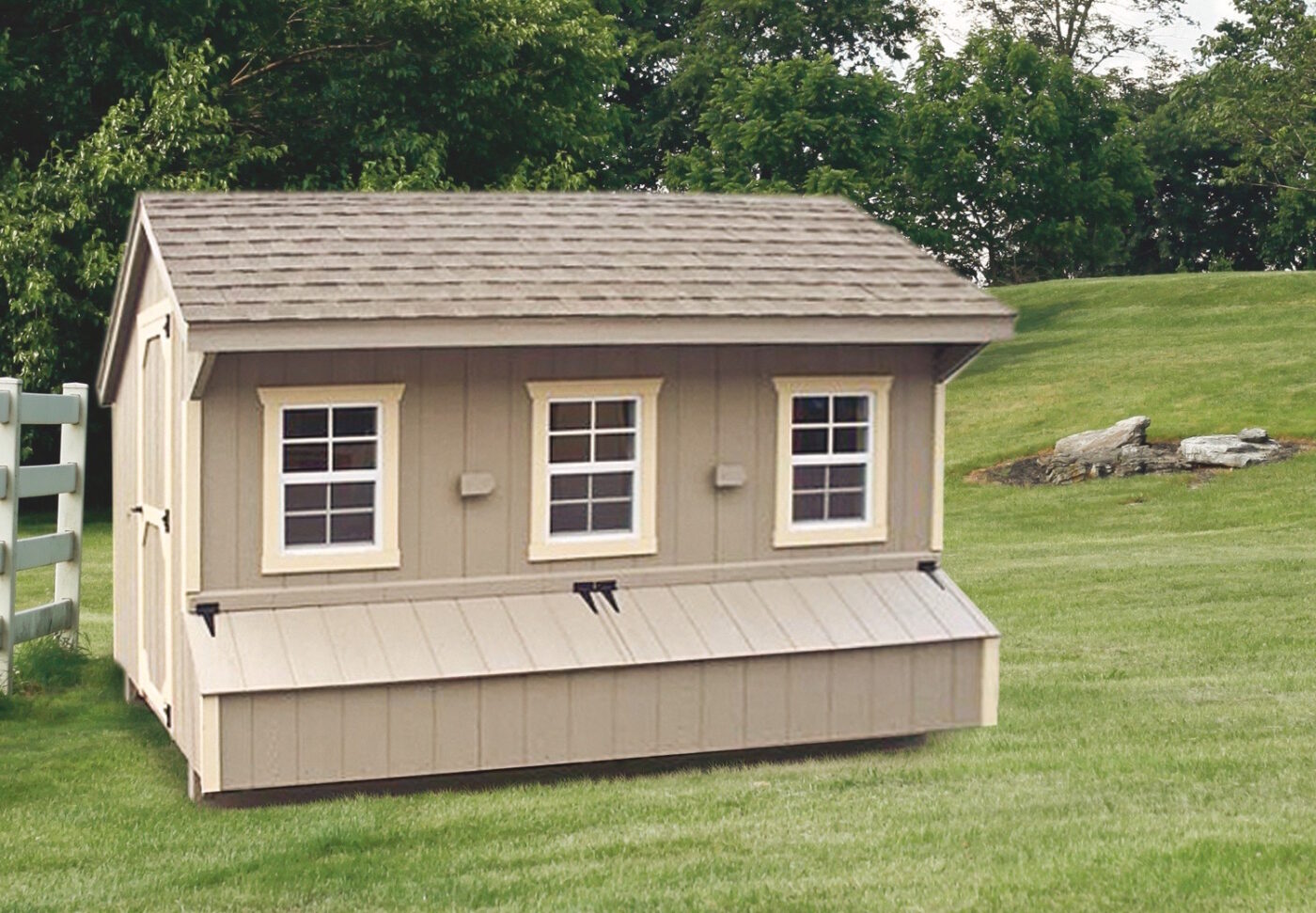 tan quaker chicken coop with three windows and an egg collection box beneath it