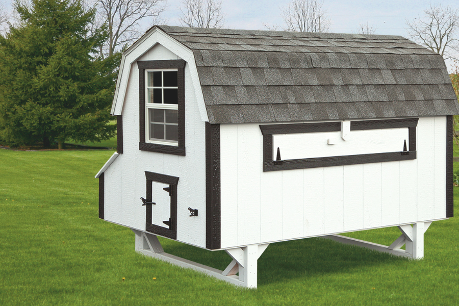 white and black trimmed dutch chicken coop with curved gray shingle roof slightly raised off ground