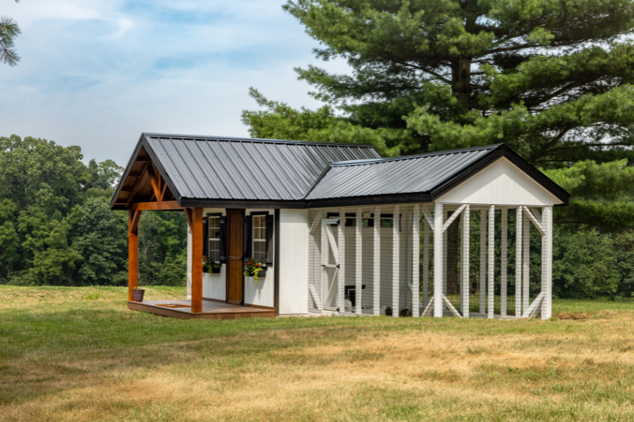 white combination chicken coop with black metal roof side run and front porch