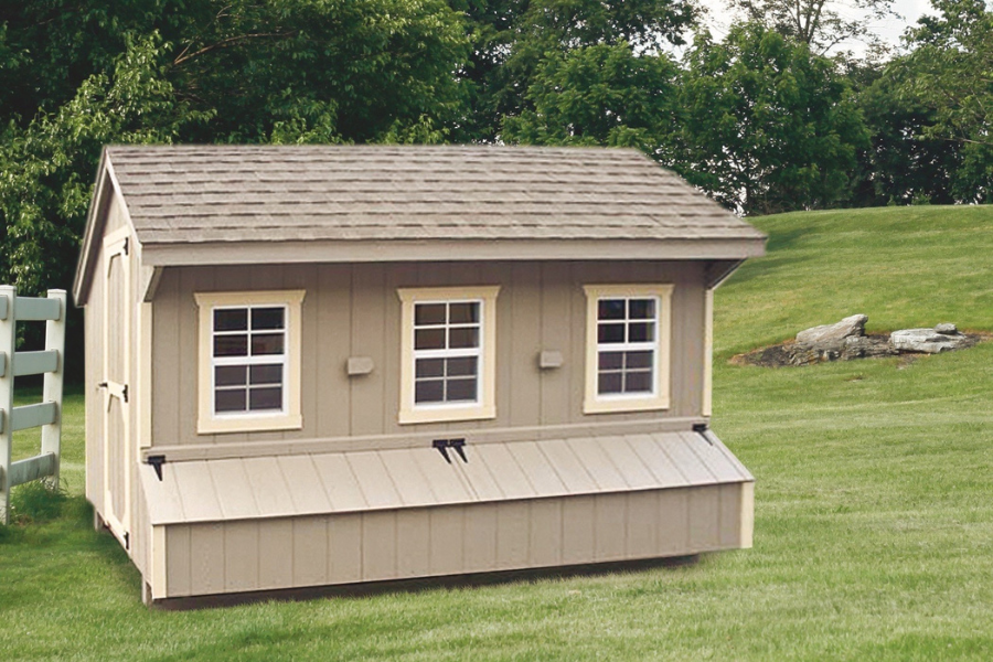 tan quaker chicken coops with shingle roof three windows and two egg collection boxes