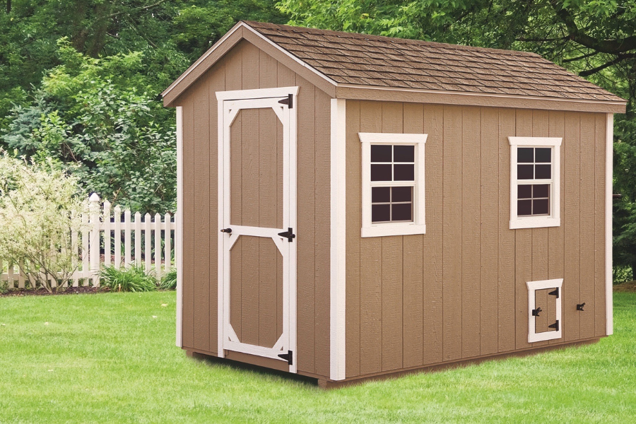 tan a frame chicken coop with white trim and shingle roof