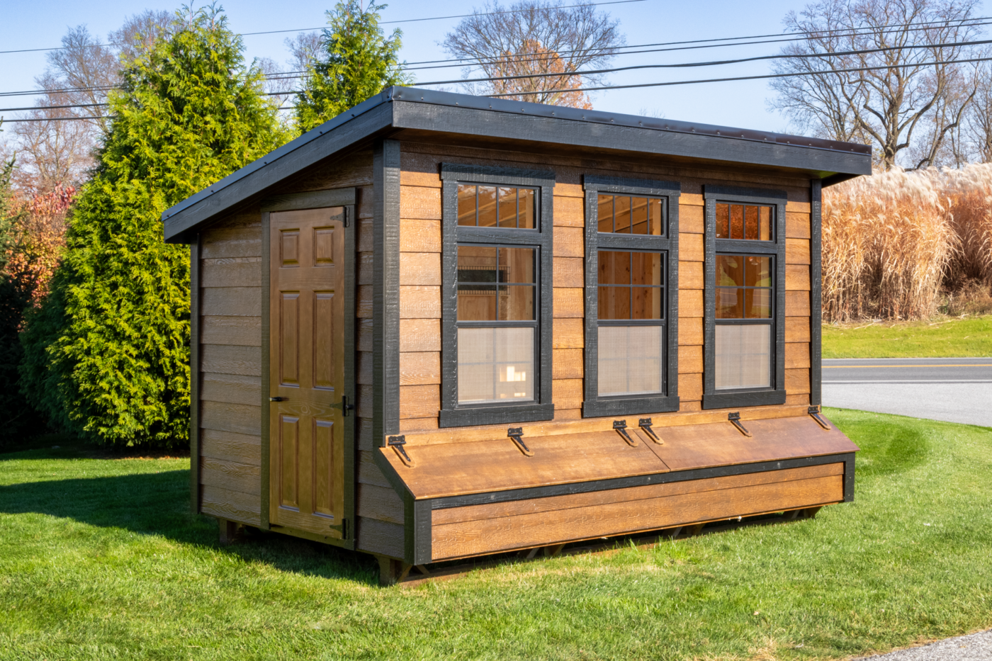 A modern Lean-To Chicken Coop in Utah with brown siding, black trim, and a single slope roof.