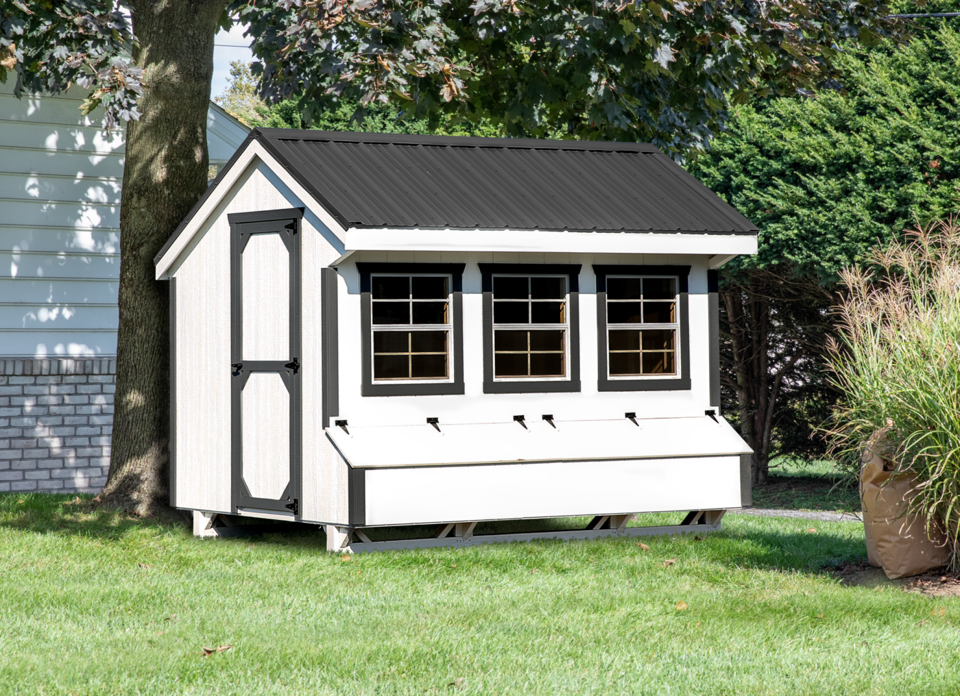 A beautiful white quacker chicken coop with gray trim in Salt Lake City UT.