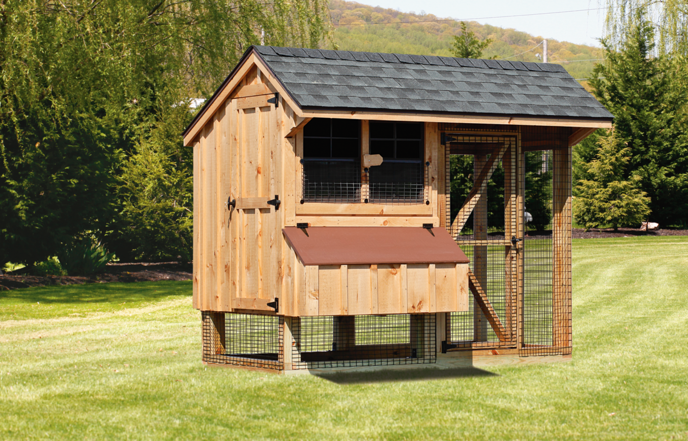 A Board & Batt siding quaker coop with an attached run and gray roof shingles.