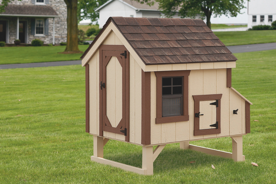 tan A frame chicken coops for sale in Huntington WV with dark brown trim and shingle roof raised off of ground