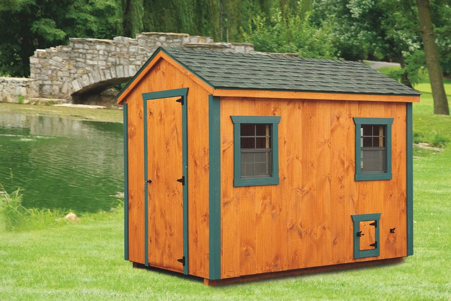 wooden a frame chicken coop with green trim and greenish shingle roof