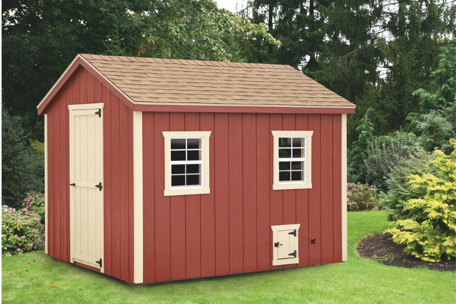 red and tan trimmed a frame coop with tan side door and chicken door and tan trim around two windows plus a tan shingle roof