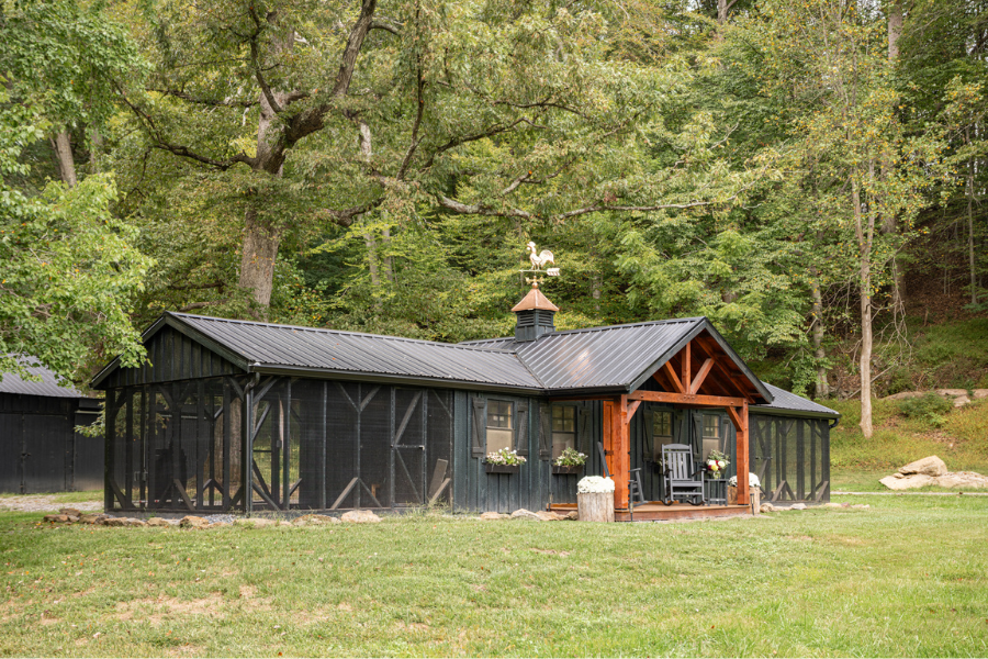 black custom combination chicken coop with attached runs on wither side front porch and cupola + weathervane