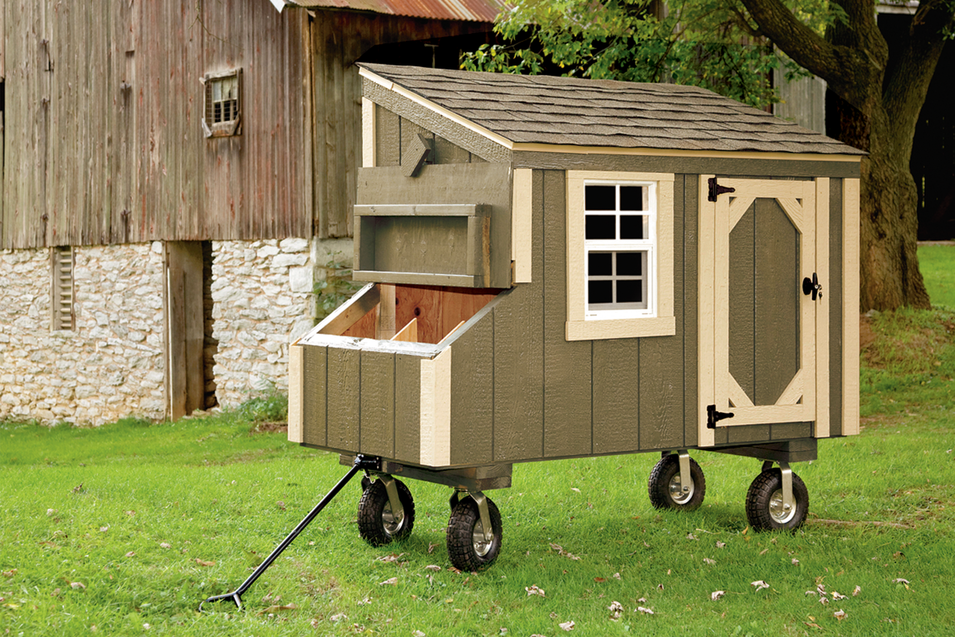 An olive green lean-to coop on wheels with a handle available to residents near West Valley City UT.