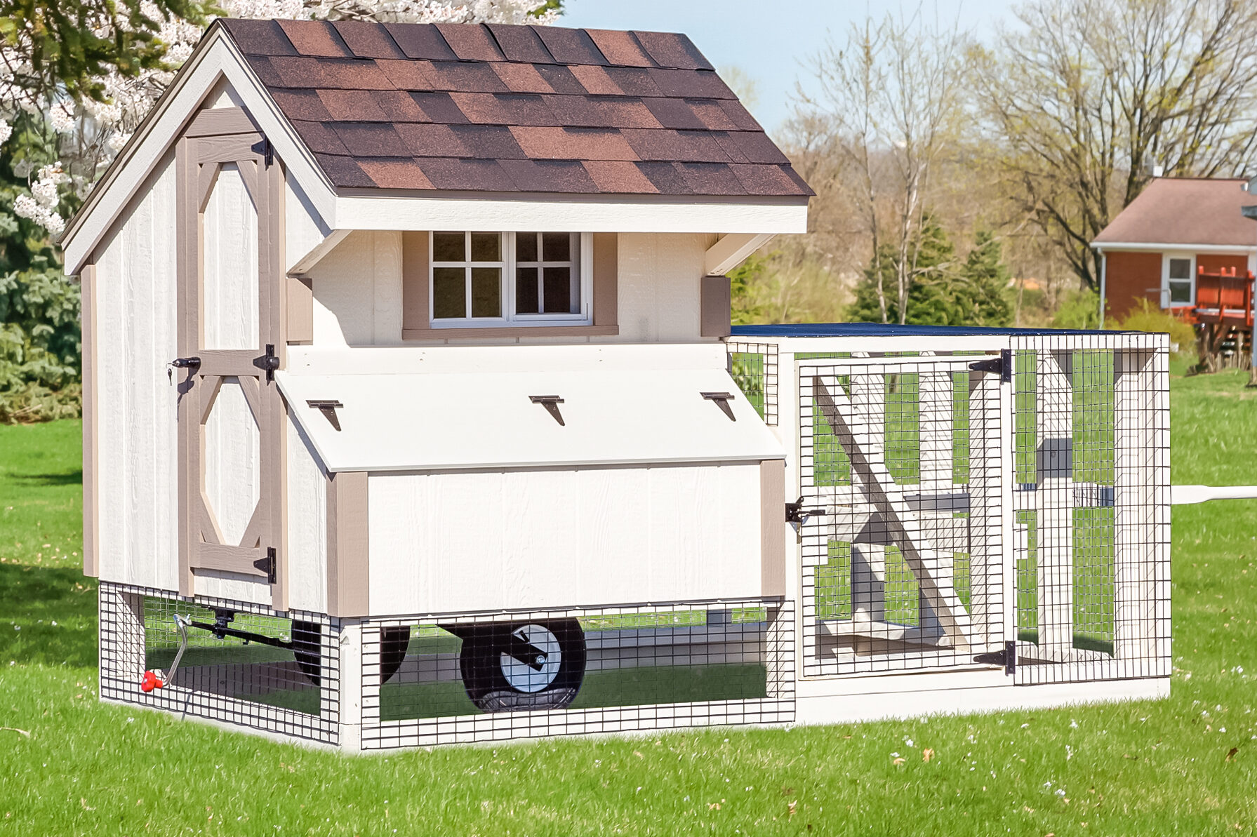 white and tan trimmed tractor chicken coop with wheels and attached run