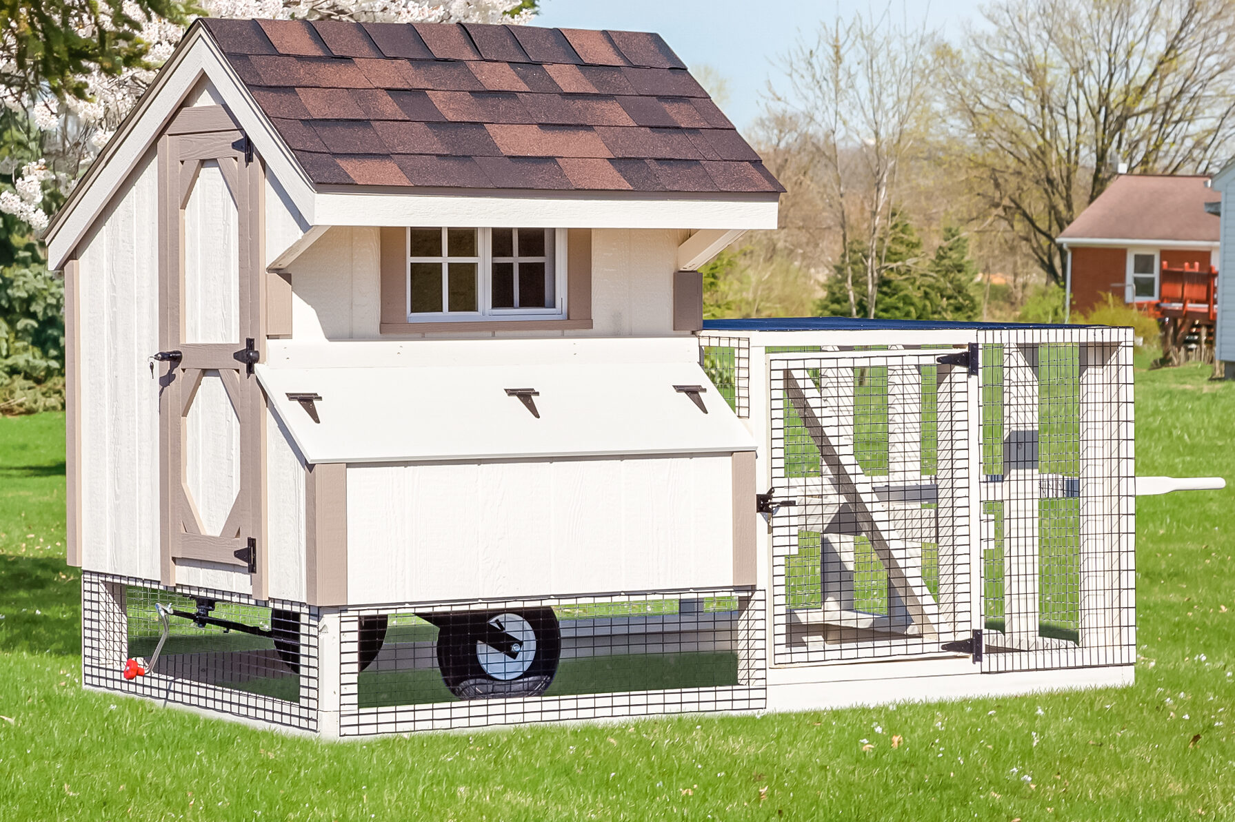 white tractor chicken coop with tan trim attached run and wheels