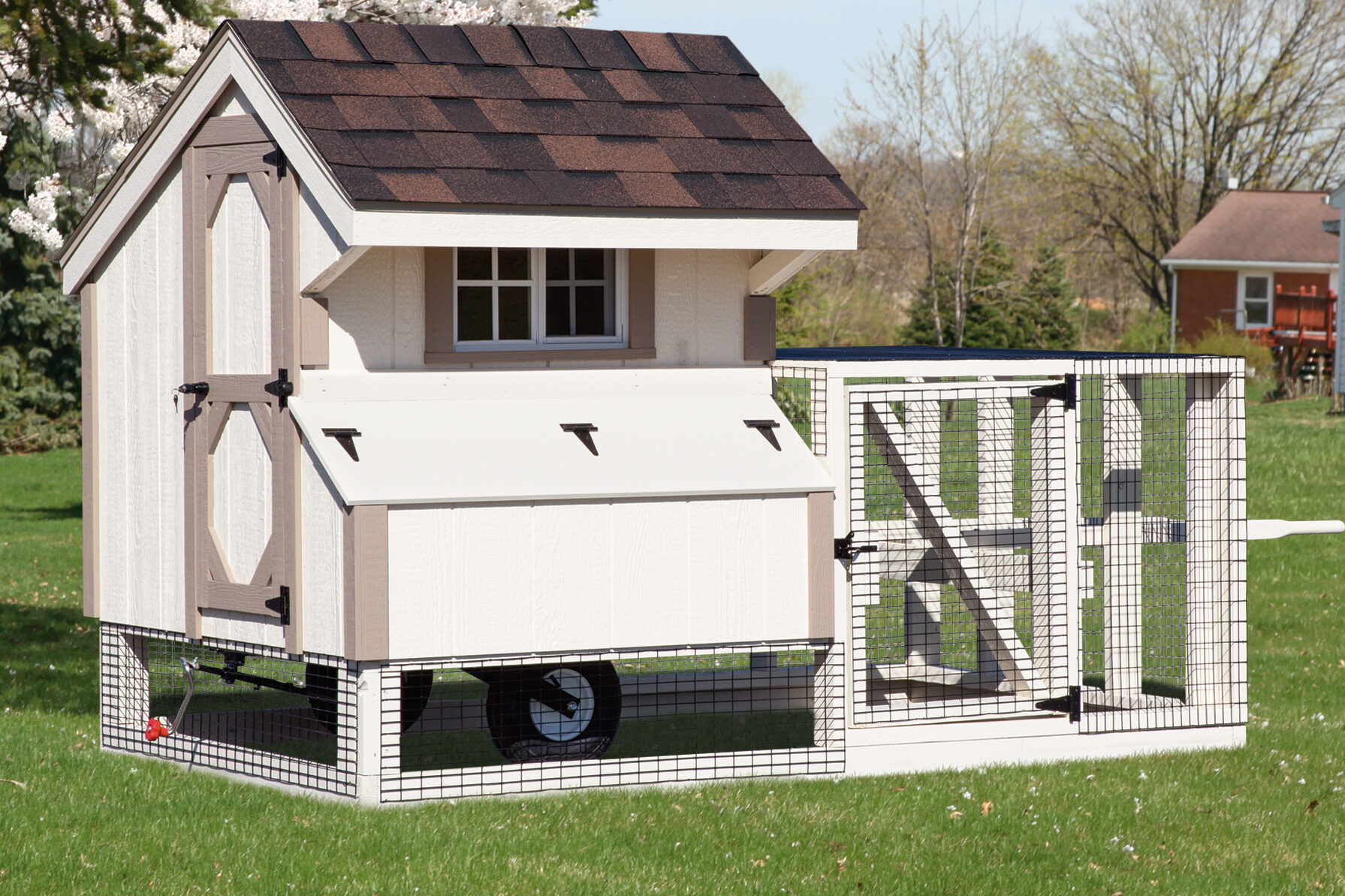 white tractor coop with tan trim wheels and outdoor run